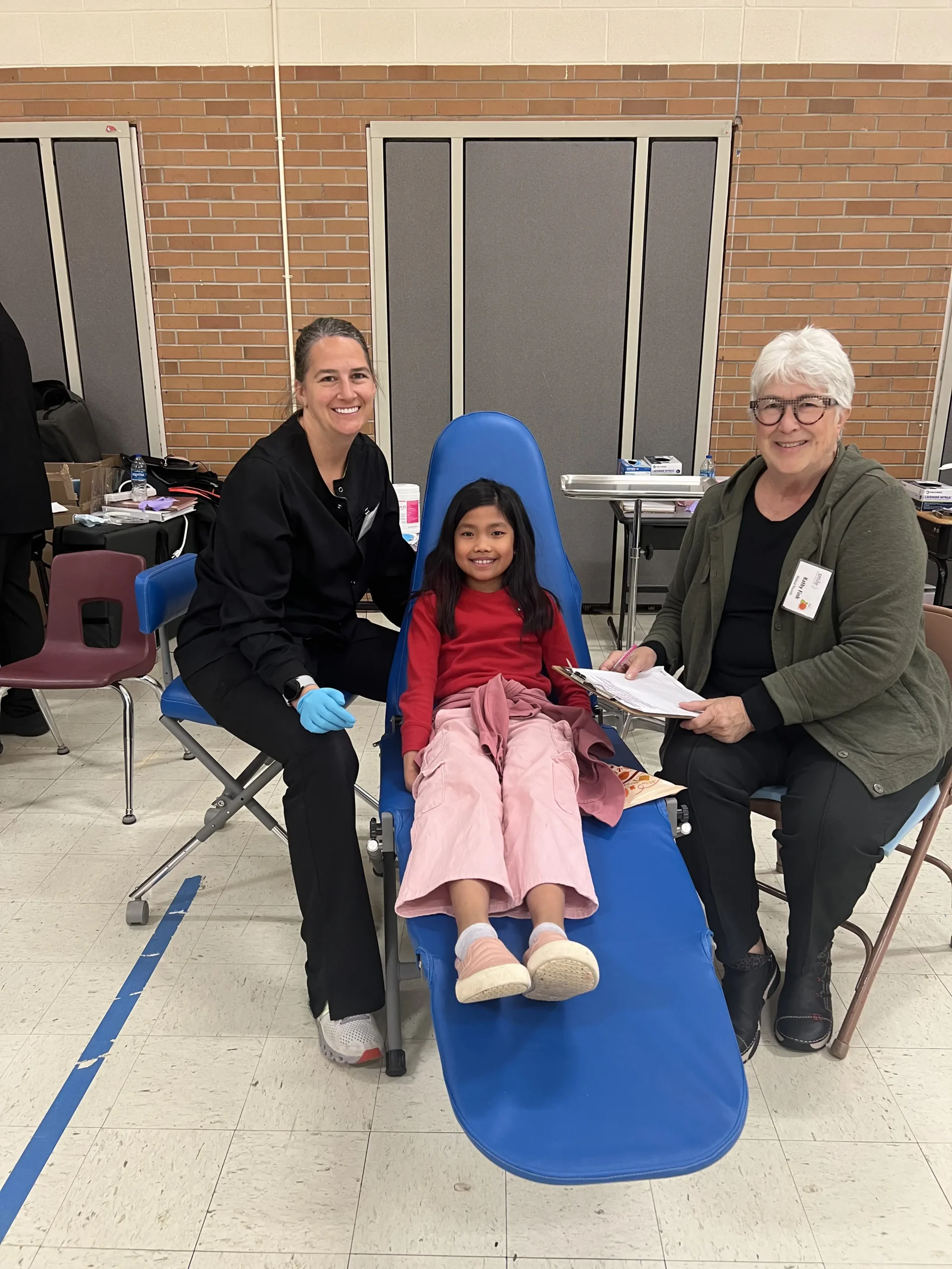 Dentists posing with a child patient | Boger Dental | Plymouth, MN